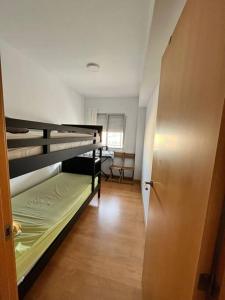 a room with two bunk beds and a door at Apartamento SALITRE in Fuengirola
