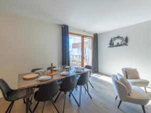 a dining room with a wooden table and chairs at Appartement Alpe d'Huez 4 adultes+2 enfants avec parking et WiFi - FR-1-645-66 in LʼHuez +9 photos