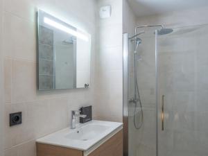 a bathroom with a sink and a shower with a mirror at Appartement Alpe d'Huez 4 adultes+2 enfants avec parking et WiFi - FR-1-645-66 in LʼHuez