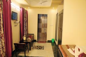 a room with a bed and a table and chairs at Nahar Singh Haveli in Jaipur