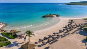 an aerial view of a beach with umbrellas and the ocean at Royalton Hideaway Blue Waters - Montego Bay, An Autograph Collection All-Inclusive Resort - Adults Only in Falmouth