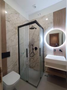 a bathroom with a shower and a toilet and a sink at Park Deluxe 6 Rooms - Free Parking in Lisbon