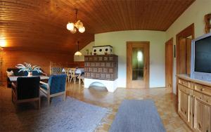 ein Wohnzimmer mit einem TV und einem Esszimmer in der Unterkunft Ferienwohnungen Leitner-Ebenberger in Greifenburg
