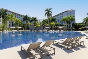 a swimming pool with chairs and a hotel at Royalton Hideaway Blue Waters - Montego Bay, An Autograph Collection All-Inclusive Resort - Adults Only in Falmouth