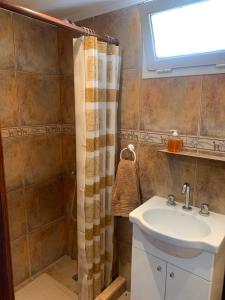 a bathroom with a sink and a shower at La casita de Sue solo para familias reserva solo con seña in Mar del Plata