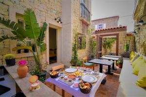 a patio with a table with food on it at Micel Otel Alacati in Alaçatı