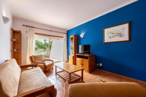 a living room with a couch and a table at Cardeira Holiday Apartments in Lagos