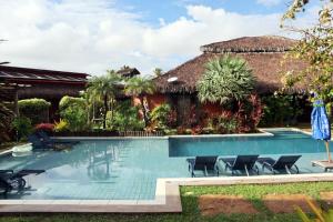 a swimming pool in front of a house at Pousada Vila Camurim in Atins