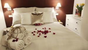 a bed with towels and flowers on it at La Dimora dei Mille in Ostuni