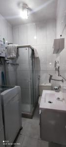a bathroom with a shower and a toilet and a sink at Ipanema Flat in Rio de Janeiro