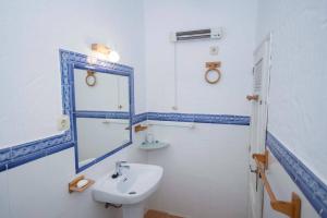 a bathroom with a sink and a mirror at GINVA - Casa con encanto en pleno centro in Vejer de la Frontera