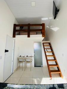 a room with a bunk bed and a table and chairs at DuPai 12 Sorocaba in Sorocaba