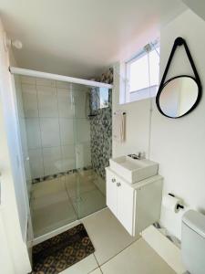 a bathroom with a shower and a sink and a mirror at DuPai 12 Sorocaba in Sorocaba