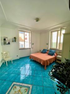 a bedroom with a bed and a blue floor at Putechella's Apartments in Maiori