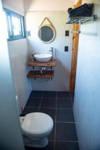 a bathroom with a toilet and a sink at El Secreto en las Sierras in Villa Serrana