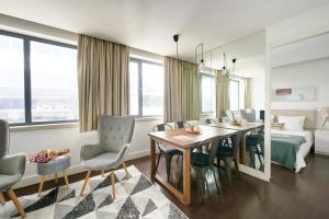 a dining room with a table and chairs and a bed at Modern Apartment Marquês in Lisbon