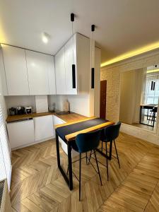 a kitchen with a table and chairs in a room at Apartament Kaszubska Bryza in Hel +13 photos