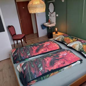 two beds in a room with a table and a chair at De Mast bij Fort Vechten on the countryside & close to Utrecht in Bunnik