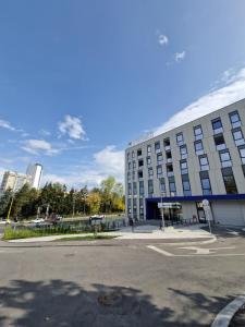an empty parking lot in front of a building at Smart Loft Apartment in Tuzla