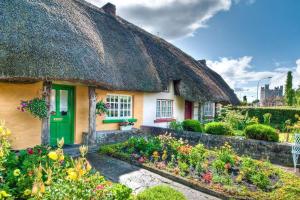 a cottage with a thatched roof with a garden at 3 bed semi-detached house in a quite estate in Bruff