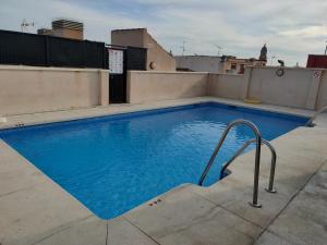 a swimming pool on the roof of a building at Ático - Piscina Málaga centro in Málaga
