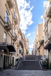 a group of stairs in a street with buildings at Gli Appartamenti al Duomo in Catania