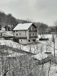 a house in a field with snow on the ground at L&L in Sarajevo +6 photos