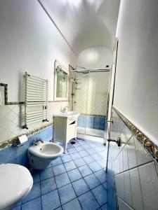 a bathroom with a toilet and a sink and a shower at Putechella's Apartments in Maiori