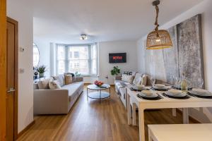 a living room with a couch and a table at Elegance at the Lanes-3BD in Brighton & Hove
