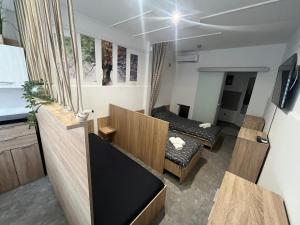 a room with two beds and a tv in it at Jóbarát Szálláshely Szeged in Szeged