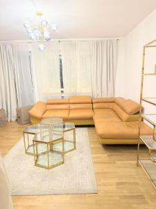 a living room with a couch and a glass table at FMI Apartmets next to Frankfurt Airport in Frankfurt/Main