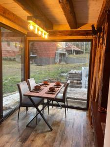 a table and chairs in a room with a large window at Villa WOLF in Divčibare +9 photos