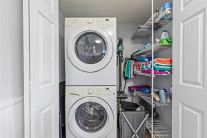 a laundry room with a washer and dryer at Kiawah Bay 106 in New Smyrna Beach