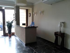 a lobby with a reception desk in a building at Hotel LB in Necochea