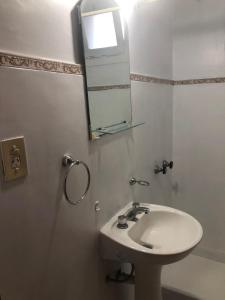 uma casa de banho com um lavatório e um espelho em Hotel LB em Necochea