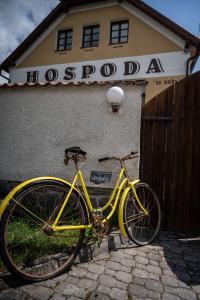 una bicicleta amarilla estacionada frente a un edificio en Hospoda na statku, en Kadov