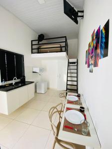 a living room with a table and a bunk bed at DuPai Sorocaba 11 in Sorocaba
