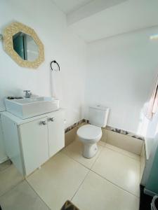 a bathroom with a white toilet and a sink at DuPai Sorocaba 11 in Sorocaba