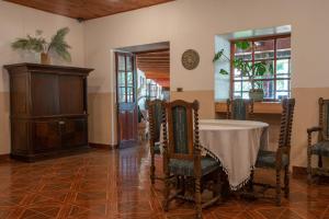 a dining room with a table and chairs and a room with a window at Hotel Linares in Linares
