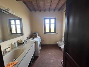 a bathroom with a sink and a toilet at Villa Cerretina in Cerreto Guidi