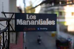 a sign that reads los mamilliles hanging on a fence at Hotel Los Manantiales in Panajachel