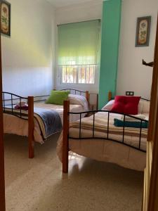 Säng eller sängar i ett rum på Alquiler Mazagon Pre-Parque Doñana