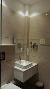 a bathroom with a sink and a toilet at Hotel Aura Grand By Levelup Hotels in Amritsar