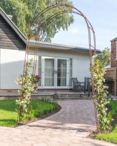 an arbor in front of a house at The Garden Room - 1 bedroom annex in Penrith in Penrith