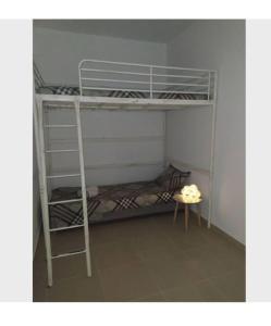 a room with two bunk beds and a table at Creta Irini's Rooms2 in Tympáki