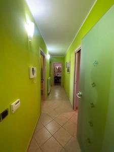 a hallway with lime green walls and a hallway with a hallway at Villa Ventosa in Surigheddu