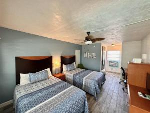 a hotel room with two beds and a ceiling at Malibu Resort Motel in St Pete Beach +58 photos