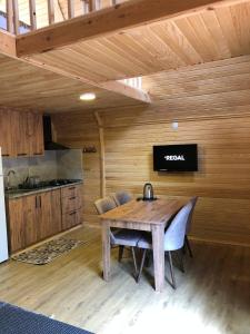 a kitchen with a wooden table and chairs in a room at Adrasan Twin Aparts in Kumluca