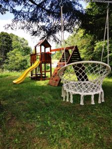 a swing in a yard with a playground at Holiday home Sovica in Vrbovsko