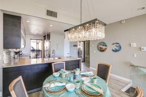 a dining room and kitchen with a table and chairs at Waterfront Long Beach Condo with Pool Access! in Long Beach